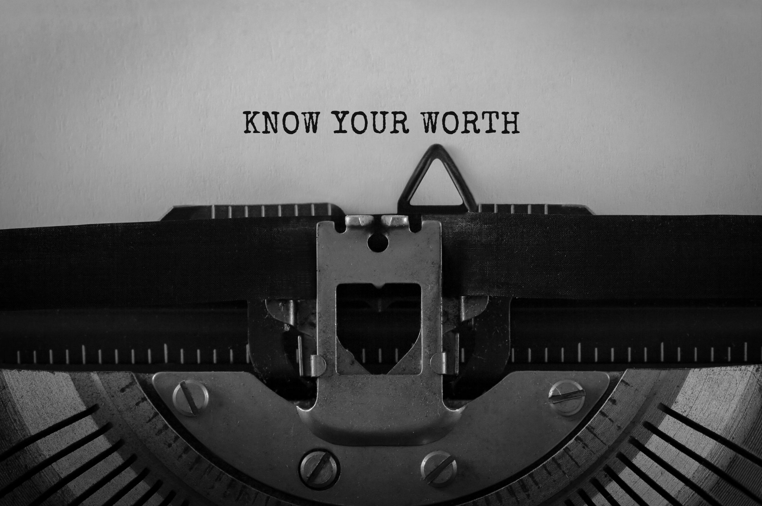 Text Know Your Worth typed on retro typewriter